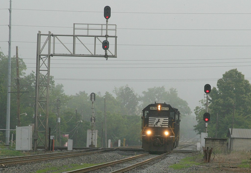 NS 6678 is running around its train through the siding 